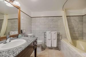 a bathroom with a sink, toilet and bathtub at Best Western- Big Bear Chateau in Big Bear Lake