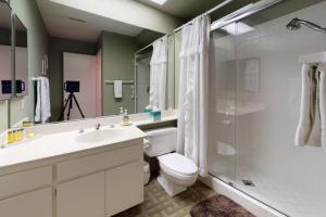 a bathroom with a toilet and a sink and a shower at DF202 Airy 2 Bedroom Condo Overlooking the Pool in Palm Desert