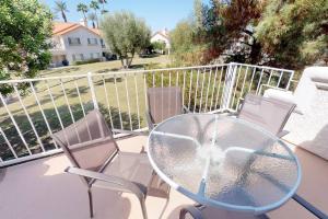 a glass table and chairs on a balcony at DF202 Airy 2 Bedroom Condo Overlooking the Pool in Palm Desert