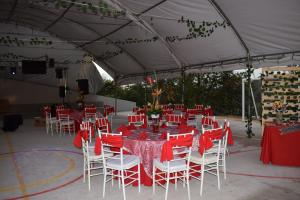 a tent with red and white chairs and tables at Finca Don Matías in Melgar +84 photos