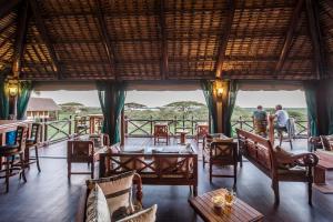 a view of a restaurant with tables and chairs at Lake Ndutu Luxury Tented Lodge in Sinoni