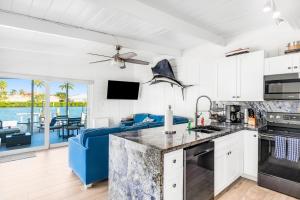 a kitchen and living room with a view of the ocean at A Wave From it All in Key Colony Beach