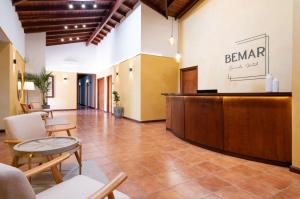 a lobby of a hotel with a reception desk at Bemar Carmelo Hotel in Carmelo
