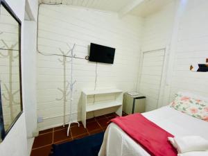 En eller flere senge i et værelse på Casa da Praia Juquehy JQY
