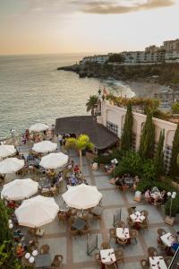 an overhead view of a patio with umbrellas and the ocean at Toboso Apar - Turis in Nerja
