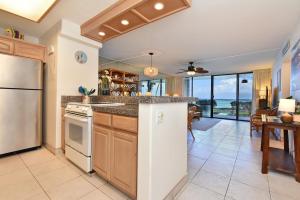 a kitchen with a refrigerator and a counter top at May on Sale! Book Now for May and SAVE BIG! in Kahana