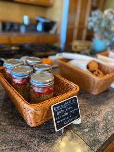 a basket filled with jars of pickles on a counter at Quiet Mind Lodge, Spa & Retreat Sequoias in Kernville +83 photos