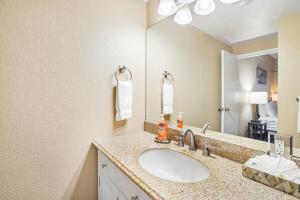 a bathroom with a sink and a mirror at Sand & Sea: The Holladay (418) in Seaside