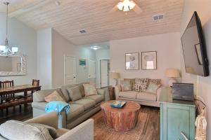 a living room with a couch and a table at Port A Good Time in Port Aransas