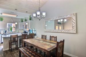 a dining room with a table and a mirror at Port A Good Time in Port Aransas +24 photos