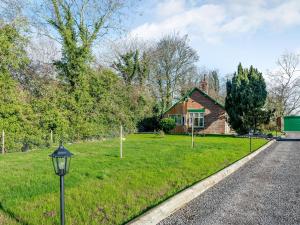 a house with a street light in front of a yard at Brickyard Cottage in Metheringham