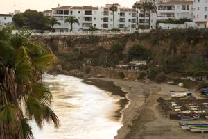 a view of a beach with boats and buildings at Toboso Apar - Turis in Nerja
