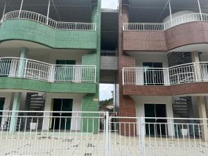 a tall building with white fences in front of it at La Lola Residencial in Bombinhas