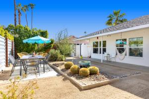 a house with a patio with a table and chairs at Amarillo House - Luxury Home with Pool & Spa in Palm Springs