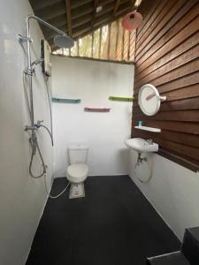 a bathroom with a toilet and a sink at Happy Hippy House2 in Ko Chang