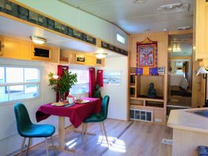 a dining room with a table and chairs in a caravan at Quiet Mind Lodge, Spa & Retreat Sequoias in Kernville