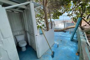 baño con aseo y árbol en Friendly Kite School, hotel and bar, en Villa Vásquez