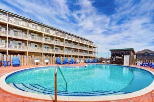 a large swimming pool in front of a hotel at Hatteras Hospitality 806 #101DS-H in Hatteras