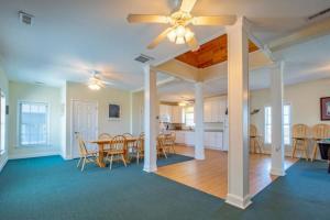 a dining room and kitchen with a table and chairs at Hatteras Hospitality 806 #101DS-H in Hatteras