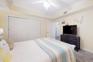 a bedroom with a bed and a flat screen tv at Paradise Shores 107 A Slice of Paradise in Mexico Beach