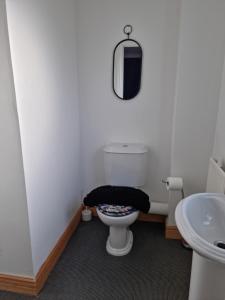a bathroom with a toilet and a sink at Driftmark Aberavon Beach The Crownlands 4 bedrooms Large Driveway parking 2 mins from Beach in Port Talbot
