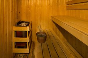 a wooden cabin with two shelves and a bucket at Toboso Apar - Turis in Nerja
