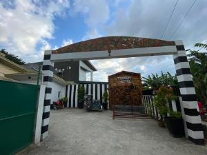 a house has a black and white checkered gate at RedDoorz @ Piamonte Apartelle Santo Tomas Batangas in Santo Tomas