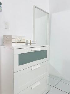 a white cabinet with a mirror on top of it at Costa Relax 2 in Guayama
