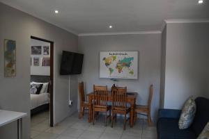 a dining room with a table and chairs at Montaña Casita - A comfortable and central cottage in Pretoria