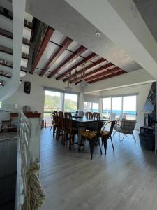 a kitchen and dining room with a table and chairs at Casa de Praia in Almagreira