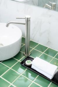 a bathroom counter with a sink and a scale at Himku Hotel - adult only in Chiang Mai