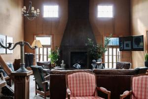 a living room with a couch and a fireplace at The Barn Daylesford in Daylesford