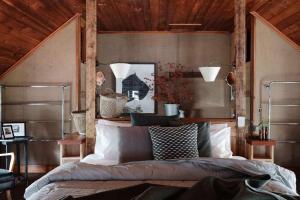 a bedroom with a bed and a wooden ceiling at The Barn Daylesford in Daylesford