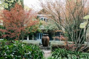 a large vase sitting in the middle of a garden at The Garden House Daylesford in Daylesford