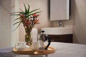 a tray with cups and a tea set on a table at Circa Ivy Prince Daylesford in Daylesford +8 photos