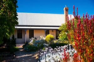 a garden in front of a house with flowers at Circa Ivy Prince Daylesford in Daylesford