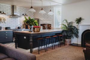 a kitchen with a large island with bar stools at The Gums - Daylesford Region in Korweinguboora