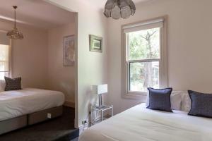 a bedroom with two beds and a window at Halina Daylesford in Daylesford