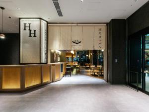 a lobby of a restaurant with tables and chairs at Akabane Holic Hotel in Tokyo