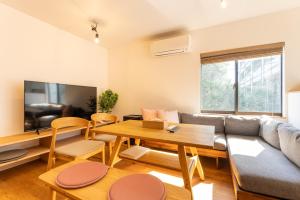 a living room with a couch and a table at 強羅base B棟 - GORA base B in Gora