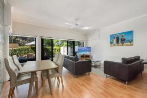 a living room with a table and a couch at Mirra Chana in Mooloolaba