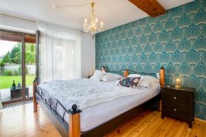 a bedroom with a large bed with a green wall at Holiday, party and relax vila 