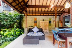 an outdoor patio with a table and chairs at Pukakoo Villas and Suite by Supala in Ubud