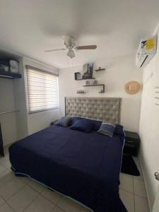 a bedroom with a blue bed and a ceiling at Cancún Smart House with pool & AquaPark in Cancún