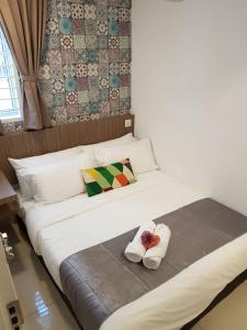 a large white bed with two pillows on it at Garden 96 inn in Kuantan