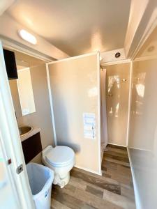 a small bathroom with a toilet and a shower at Son's Rio Cibolo Glamping Cabin #G Brand New Creek-front Cabins with SO Many Amenities! in Marion