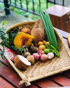 a basket filled with fruits and vegetables on a table at Downtown Hostel Ella in Ella