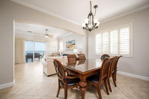 a dining room with a table and chairs and a couch at 835 Cinnamon Beach, 3 Bedroom, Sleeps 8, Diamond Rated, Ocean Front, 2 Pools in Palm Coast