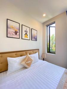 En eller flere senge i et værelse på Dawn Villa Homestay Hội An