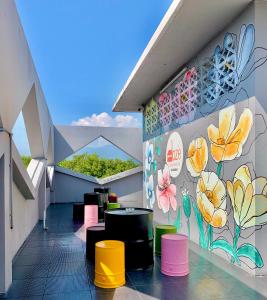 a room with a mural of flowers on the wall at Doze Hostel in Chiang Mai